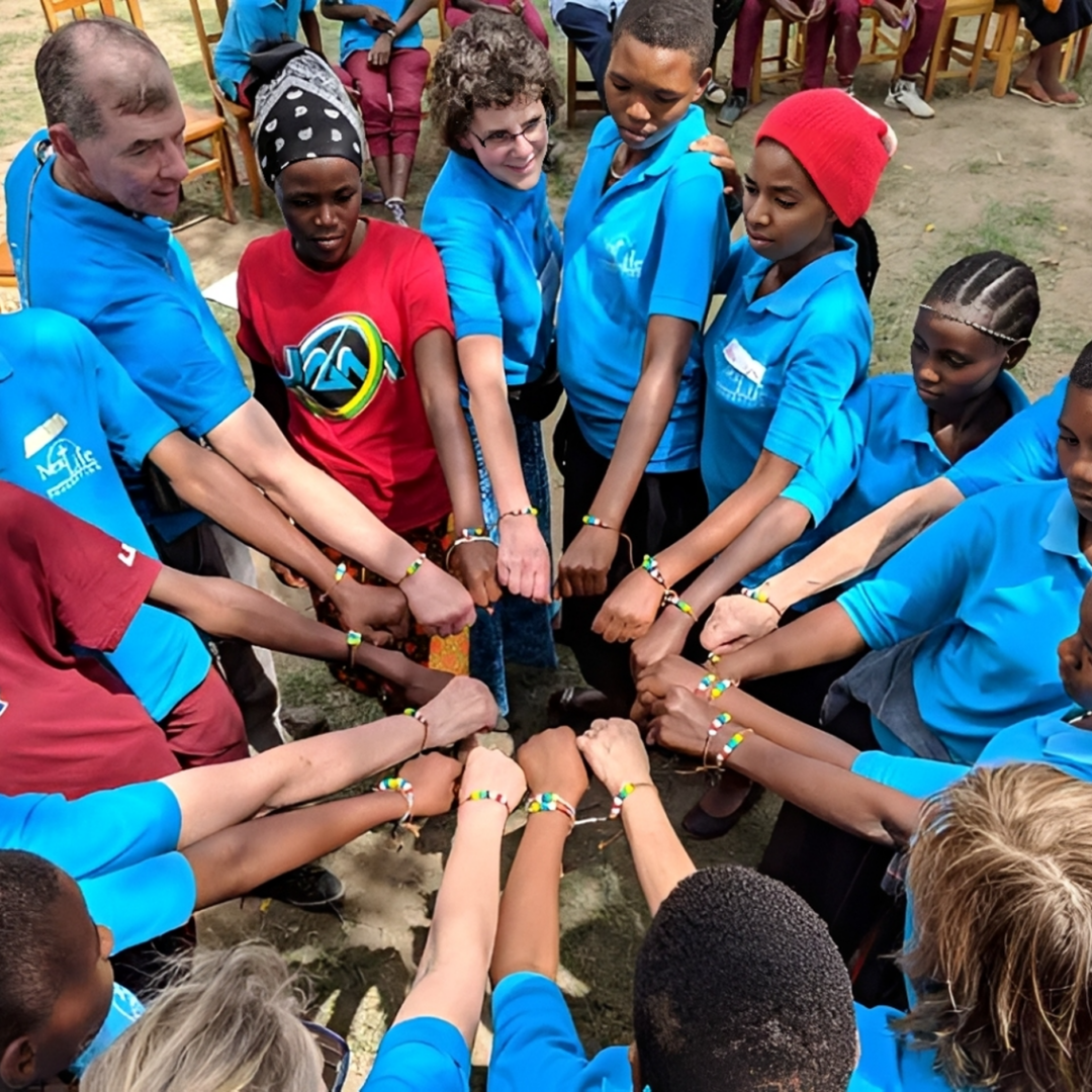 People in a circle showing colorful bracelets.